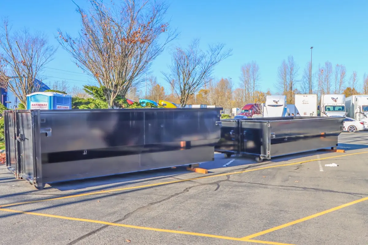 Professional dumpster rental service with roll-off container on residential driveway in Webb City